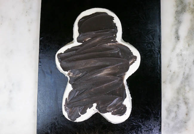 Applying the Black Buttercream to the Gingerbread Man Cake | Erin Bakes