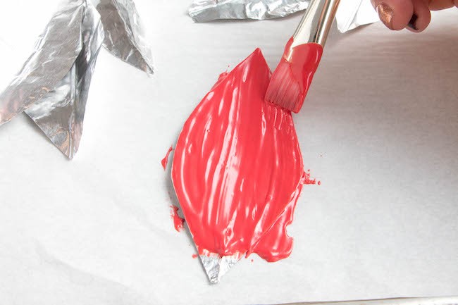 Brushing a Foil Leaf Mold with Melted Red Coating Chocolate | Erin Bakes