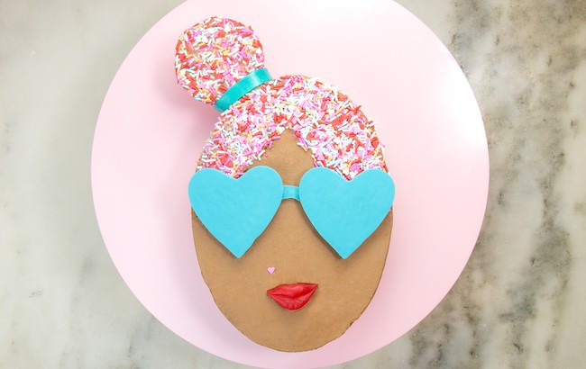 Oval cake finished with chocolate buttercream, sprinkle hair, and chocolate sunglasses | Erin Gardner | Erin Bakes