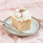 Slice of cranberry sauce spice cake with cream cheese frosting